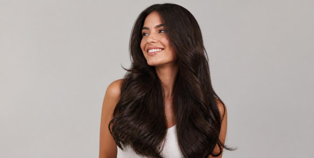 Woman with full voluminous hair after extensions, restore volume after autumn hair loss at Hair Nova Finchley